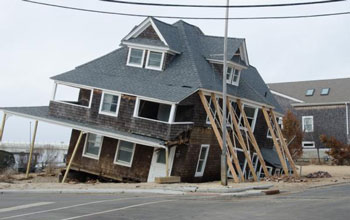 a home destroyed by impacts of a hurricane