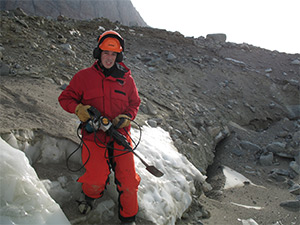 LSU graduate student Shawn Doyle carries a demolition hammer used to excavate the sampling tunnel.