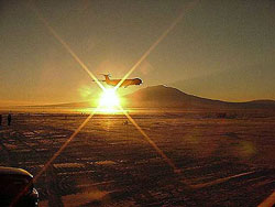 Photo of plane silhouetted by the sun