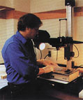 Microbiologist Mark Burr prepares to stain amplified DNA with ethidium bromide to measure the bacterial content of ultrapure water used to process semiconductor wafers.