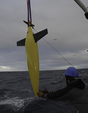 Scientist with a seaglider as it's lowered into the ocean