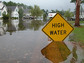 Flooded area with high water sign