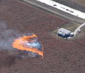 The experimental grass fire spreads through instrumentation placed in a research plot.