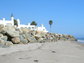 Large rock revetment in the intertidal zone of a sandy beach in Santa Barbara County, California.