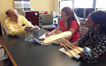 Bruce Bukiet with undergraduate students and a model plane.