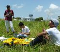 students in a field collecting insects