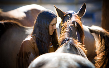 'He Stalks One' of the Lakota Nation connects with a horse