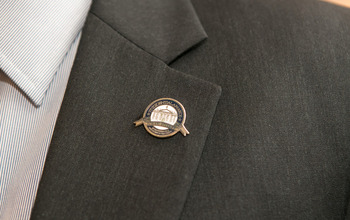 A PAEMST awardee displays his new lapel pin.