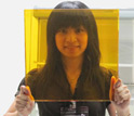 Photo of team member Vivian Sieh holding up the photorefractive polymer.