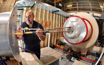 A researcher performs calibrations on the Sandia Lightning Simulator.