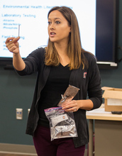 a woman stands in a classroom