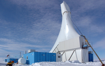 a drilling rig in the Antarctic with blue skies in the background