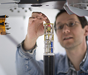 A scientist places a small sample into a tube