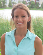 Woman with blond hair and a teal top