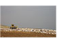 A piece of heavy equipment pushes trash in a landfill.