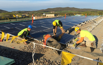 Technicians installing solar panels