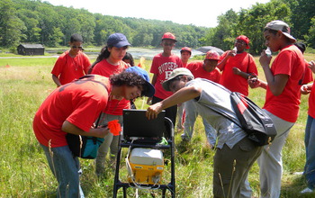 Rutgers-Newark graduate students  with high-school student and a ground-penetrating radar