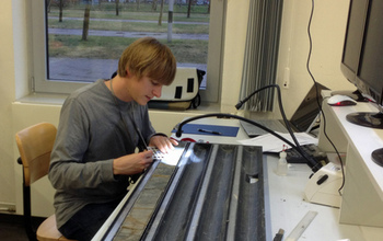 Geochemist Gabe Bowen working on a sediment core in the lab.