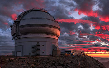 Sunlight paints a crimson sky over Gemini South