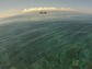 An NSF Moorea Coral Reef LTER site research boat is moored on an outer reef; background is Tahiti.