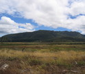 Mt. Tarawera volcano in New Zealand. A past eruption produced the domes that formed the hills.