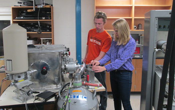 Students adjust the target wheel and detectors near a beam outlet