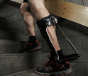 man climbing stairs with a passive-elastic ankle exoskeleton attached