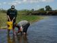 UAV-based hyperspectral imaging research at Montana State University, with students collecting samples from a stream while a UAV collects data from overhead