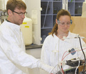 Scientists Carl Lamborg (left) and Gretchen Swarr of WHOI working in the lab