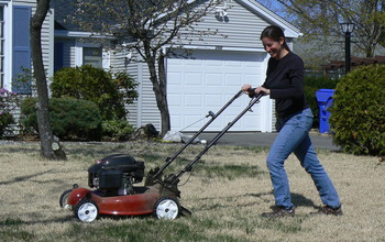 Woman mowing a lawn.