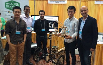 Researchers and students from MIT showcase a model of a smart, autonomous tricycle