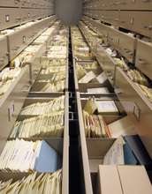 rows of paper packets and cardboard boxes in cabinets