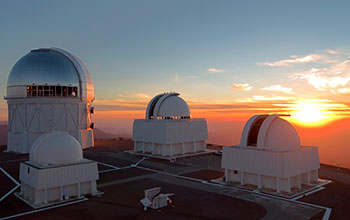 The sun sets on the domes of the Cerro Tololo Inter-American Observatory in Chile
