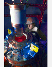 Physicist Mike Crisler inspects the bubble chamber at COUPP facility at Fermilab.