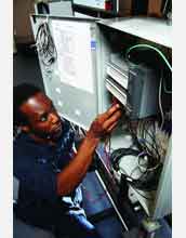 Engineering technicians use programmable logic controllers to monitor manufacturing processes