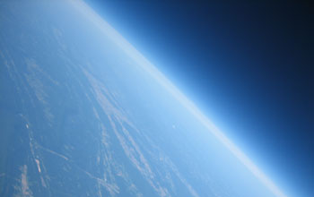 Image showing curvature of the Earth and thin veil of its atmosphere, along with Susquehanna River far below.