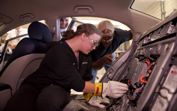 Students access the battery system during a class on automotive power systems at an ATE Center
