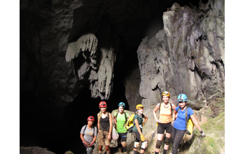 Researchers stand at the entrance to Cobweb Cave in Gunung Mulu National Park, Borneo