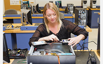 A technician uses a hardware write-blocker