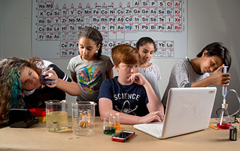 Students performing experiments in the classroom
