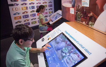 Kids use Pixar's Ratatouille interactive display at the Museum of Science.