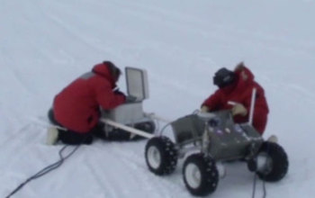 researchers with robotic vehicle in Antarctica
