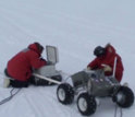 researchers with robotic vehicle in Antarctica