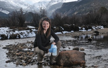 Researcher with water sample taken from the Big Thompson River