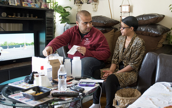 man talks to resident woman in a livingroom