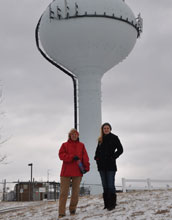 Engineers standing by a water tower