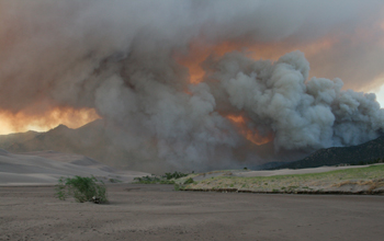 Smoke of the Medano Fire in Sand Dunes National Park blows toward the dunes