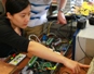 two students with electronic devices for the electric power transmission system.