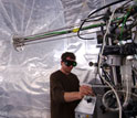 Photo of scientist fine-tuning instrumentation before an experiment in smog chamber in Switzerland.