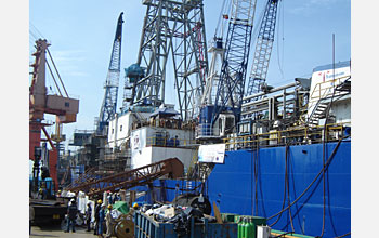 Photo of ocean drilling ship loading or unloading cargo.